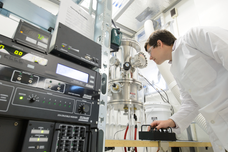 Stephen Stagon a doctoral student of mechanical engineering, with nanorod growing apparatus 